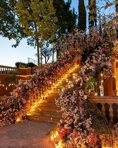 the stairs are covered with flowers and lit candles for an elegant touch to any outdoor space