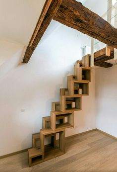 a wooden stair case in an empty room