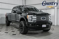 a large black truck parked in a garage