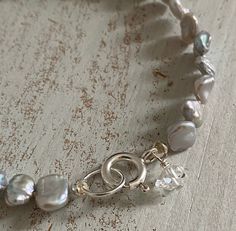 Super Iridescent 7-8mm Grey Freshwater Keshi Pearls strung on ivory silk. Finished with a simple Sterling Silver spring clasp with a dainty detail of a AAA Grade, water clear, raw and uncut 7mm Herkimer Diamond drop. Measures approximately 7.25 inches in length. A One-of-a-Kind Creation. Herkimer Diamond Bracelet, Winter Earrings, Ivory Silk, Keshi Pearls, Diamond Drops, Silver Spring, Herkimer Diamond, Earrings Collection, Earring Necklace