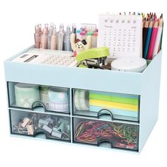 an organized desk drawer filled with lots of crafting supplies and pencils on top of it