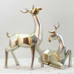 two metal deer sculptures sitting next to each other