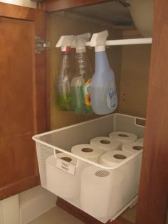 a tweep that is on top of a shelf with toilet paper and cleaning products in it