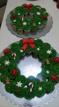 two cupcakes are decorated with green frosting