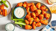 chicken wings with celery and ranch dressing on a plate