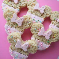 some kind of doughnut with sprinkles and bow decorations on it's sides