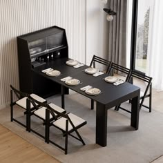 a dining table with four chairs and plates on it in front of a sliding glass door