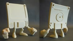 two white plastic objects with faces and legs