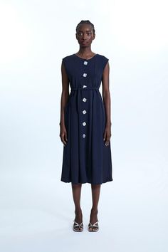 James Lakeland is revisiting classic lines marrying sophistication and comfort with this long crepe of jersey sleeveless dress. Featuring two practical front pockets, square mother-of-pearl buttons, and clever sashes sawn into the garment at the back to cinch the waist. Alternatively, wear it open as a chic long cardigan. Midi Dress Navy, Petite Coat, Sleeveless Midi Dress, Navy Midi Dress, Petite Tops, Mother Of Pearl Buttons, Midi Dress Sleeveless, Pearl Buttons, Petite Dresses