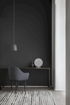 a gray chair sitting in front of a wooden table