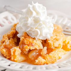 a close up of a plate of food with whipped cream on top