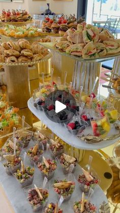 a table filled with lots of desserts and pastries on top of trays