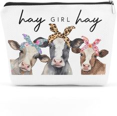 a white bag with two cows wearing headbands and the words hay girl on it