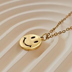 Brighten her day with our 18K Gold Filled Smiley Face Necklace and Earrings Set. Made from stainless steel, this happy face jewelry set features a smile emoji pendant and matching earrings, perfect for adding a touch of joy to any outfit. It's a delightful and charming gift for her, sure to bring smiles. ✨Product Features ✨ 🌸 Handcrafted with Passion: 💧 Waterproof Perfection: 🚀 Same Day Shipping: 💎 Material * Stainless Steel All the rings, bracelets, piercings, necklaces, and earrings we designed as Unique Jewelry were produced for you with modern lines to compliment your elegance. 👻 🚚 Shipping & Production Time 🏭 🎁 All of our items will be sent in a beautiful jewelry box ready for gift. 🚚 Free and Same Day Shipping 🌍 2-3 Business days to All Countries ↩️ Return and Exchange Poli Minimalist Jewelry With Smiley Face, Minimalist Smiley Face Round Jewelry, Smiley Face Necklace, Smile Emoji, Face Jewelry, Face Jewellery, Face Necklace, Pendant For Women, Necklace And Earrings Set