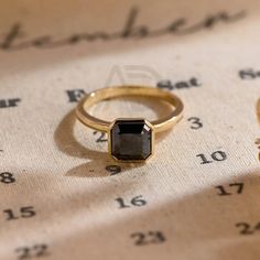 two rings sitting on top of a table next to an eyeglass case with numbers