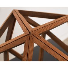 a wooden structure with four intersecting sections on it's sides and the top part of its