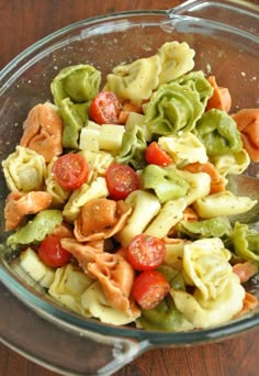 a glass bowl filled with lots of different types of salads and veggies