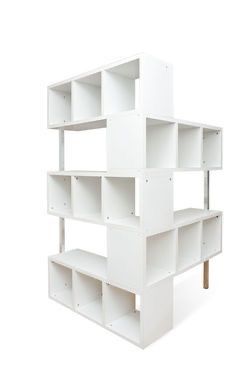 a white shelving unit with four shelves on each side and one shelf in the middle