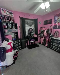 a bedroom decorated in pink and black with lots of clothes on the bed, dressers and shelves