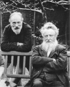 an old black and white photo of two men sitting on a bench with their arms crossed