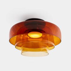 an orange and yellow light fixture hanging from the ceiling