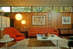 a living room filled with furniture and lots of windows on top of the wall next to each other