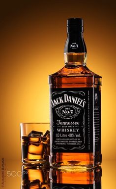 a bottle of jack daniels whiskey next to two glasses