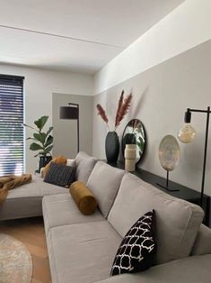 a living room filled with furniture and lots of windows