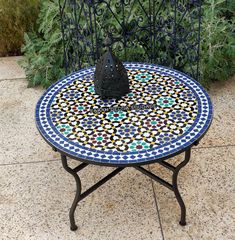 a small table with a black umbrella on it