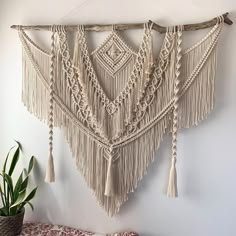 the wall hanging is made with macrame and tassels