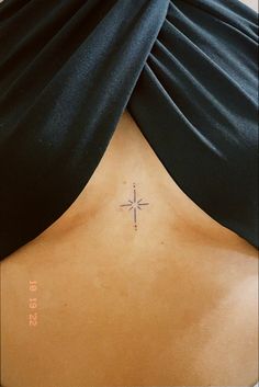 a woman with a cross tattoo on her back