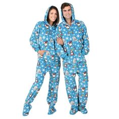 two people in matching pajamas standing next to each other with snowflakes on them