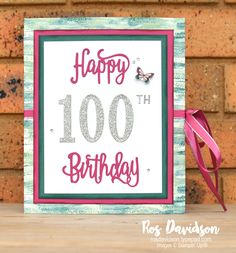 a birthday card with the words happy 100th birthday on it and a pink ribbon