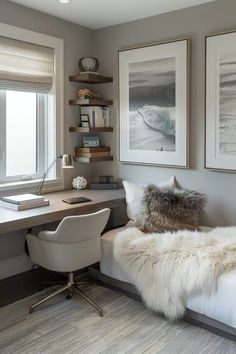 a white bed sitting next to a desk with a computer monitor on top of it