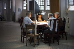 four people sitting at a table in a room