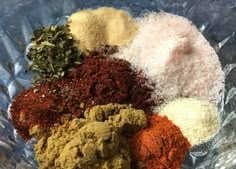 various spices in a glass bowl on a table