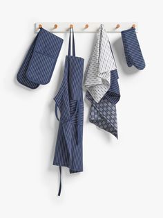 several blue and white towels hanging on a hook