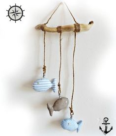 three sea animals hanging from a rope on a wall