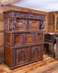 an old wooden dresser with ornate carvings on it