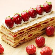 a piece of cake with strawberries on top