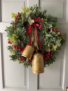 a wreath with two bells hanging from it