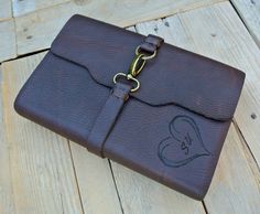 a brown leather case sitting on top of a wooden floor