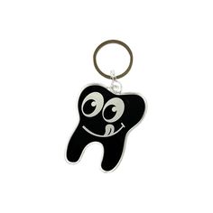 a black tooth shaped keychain with a smile on it's face and eyes