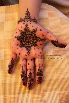 a person's hand with henna tattoos on it