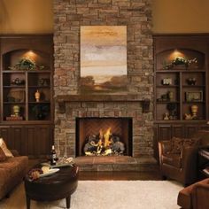 a living room filled with furniture and a fire place in the middle of a fireplace