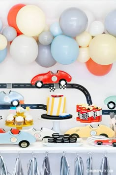 a birthday party with cars and balloons