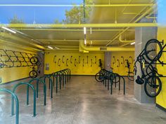 an indoor bike parking garage with yellow walls