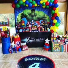 a birthday party with balloons and decorations for the avengers 4 theme is pictured in this image