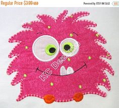 a close up of a very cute looking pink object with big eyes and green eyes