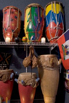 several different types of african drums are on display